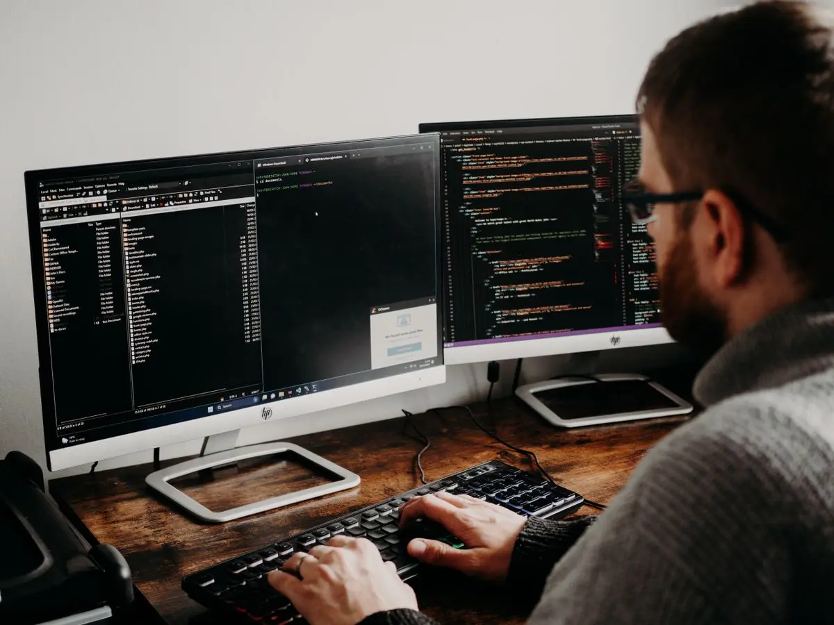 A developer working across multiple code screens